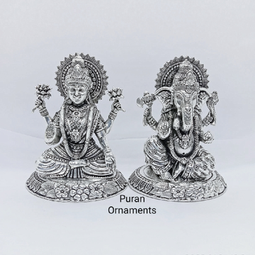 Pure silver laxmi ganesh idols in high finishing a...